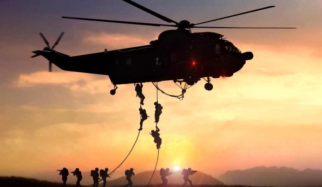 Helicopter drops soldiers at sunset