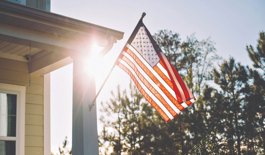 US flag flying on the front porch of a home