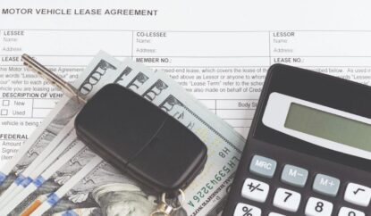 Car keys and calculator on top of cash