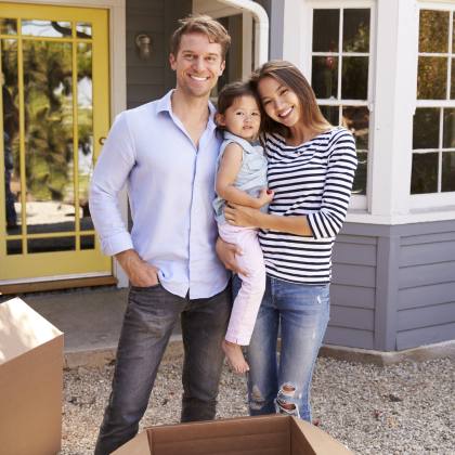 Family with new home and moving boxes