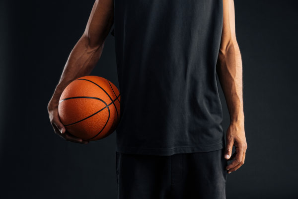 Single man holding a basketball.