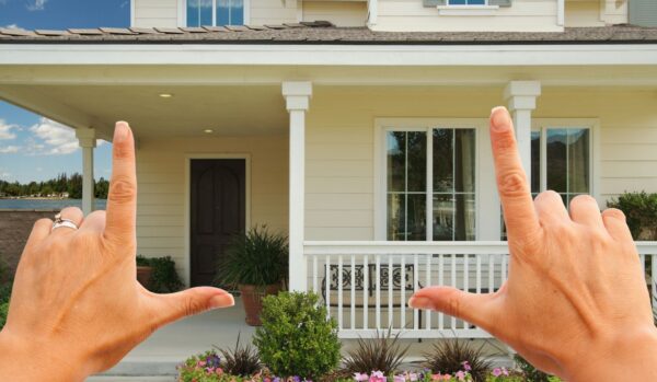 Hands framing an image of a house