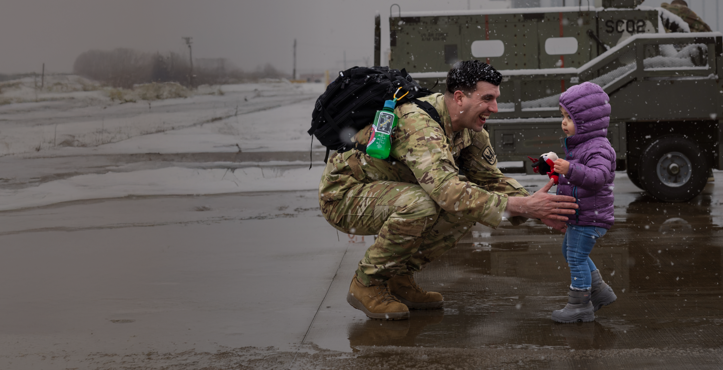 Military member greets his young daughter.