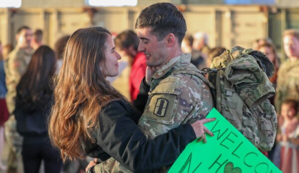 Military Spouse greeting her loved one after deployment.